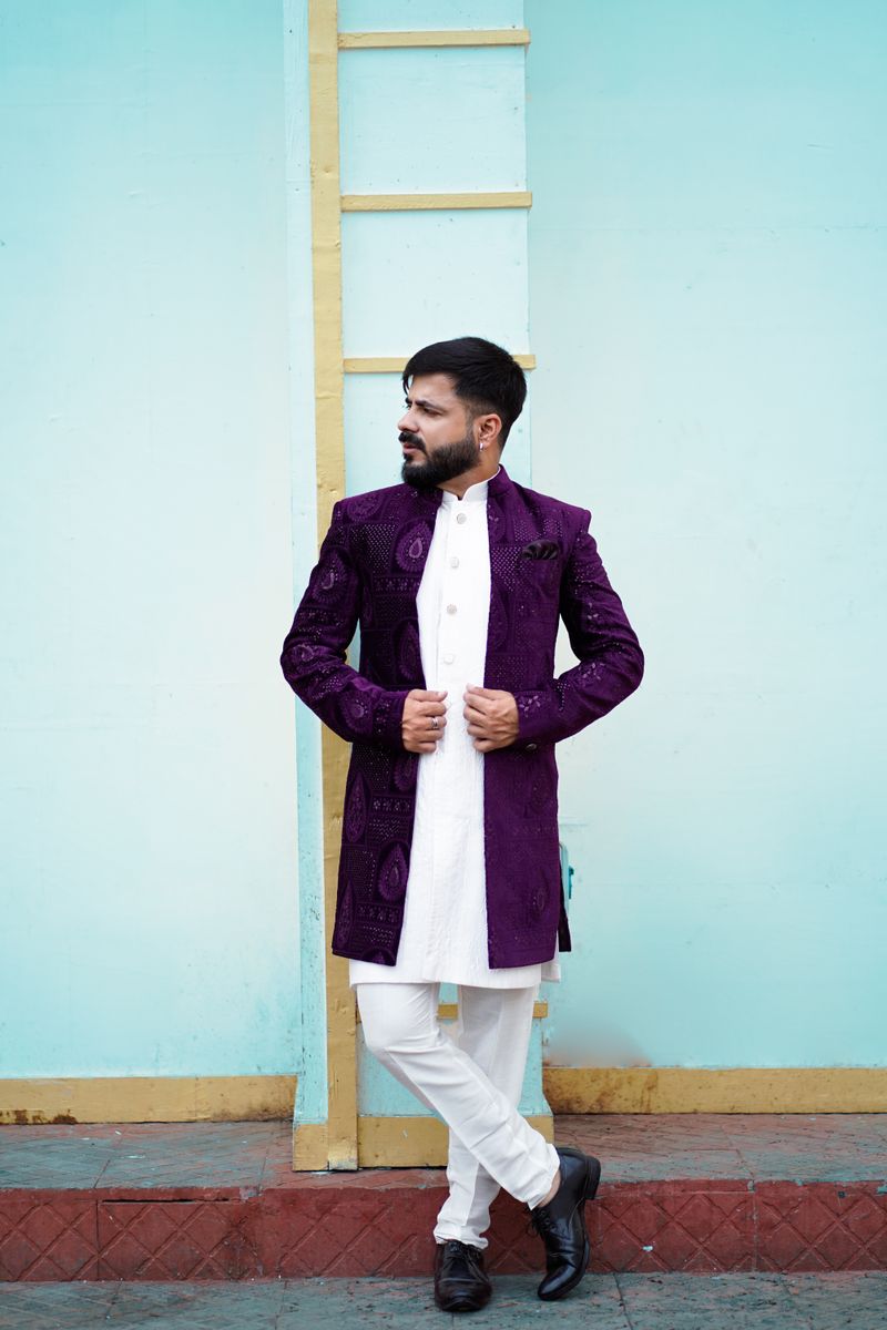 Man in a plum embroidered bandhgala over a white kurta